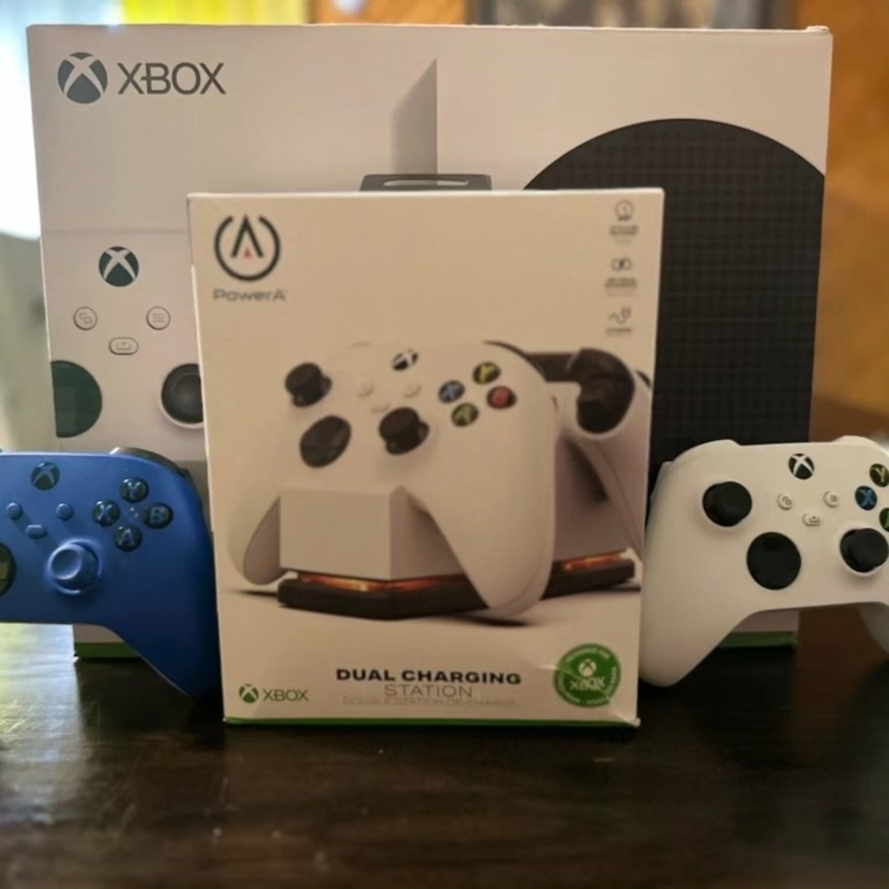 Xbox series s with three controllers and wireless charging stations